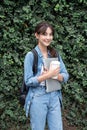 Portrait of young Asian woman student standing with laptop coffee and backpack.College Teenager University concept. Royalty Free Stock Photo