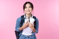 Portrait of young Asian woman student standing with smartphone coffee and backpack.College Teenager University concept. Royalty Free Stock Photo