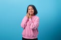 Portrait of young Asian woman touching cheek while suffering from terrible toothache