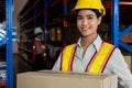 Portrait of young Asian woman warehouse worker smiling in the storehouse Royalty Free Stock Photo