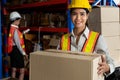 Portrait of young Asian woman warehouse worker smiling in the storehouse Royalty Free Stock Photo