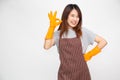 Portrait of young Asian woman wearing orange rubber gloves for hands protection during cleaning and showing ok sign.