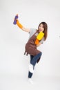 Asian woman wearing orange rubber gloves for hands protection and holding cleaning products and yellow sponge