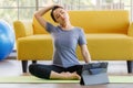 Portrait of young  Asian woman wearing sportswear sitting and looking on a computer screen doing stretching after exercise. Health Royalty Free Stock Photo