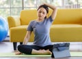 Portrait of young  Asian woman wearing sportswear sitting and looking on a computer screen doing stretching after exercise. Health Royalty Free Stock Photo