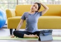 Portrait of young  Asian woman wearing sportswear sitting and looking on a computer screen doing stretching after exercise. Health Royalty Free Stock Photo