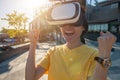 Portrait of young Asian woman wearing virtual reality goggles and enjoying the VR simulation experience. Royalty Free Stock Photo