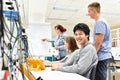 Portrait of young Asians in vocational training, in the background group of apprentices and teacher in class