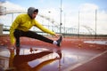 Portrait of young athlete man in windbreaker preparing to exercise