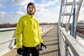 Portrait of young athlete man in windbreaker preparing to exercise