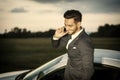 Handsome young man by his car with cell phone Royalty Free Stock Photo