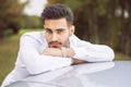 Handsome young man next to car in white shirt Royalty Free Stock Photo