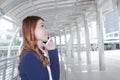 Portrait of young attractive Asian business woman talking on phone for his work at sidewalk of city background. Royalty Free Stock Photo