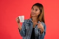 Young attractive asian coffee lover girl in studio