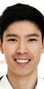 Portrait of young attractive asian creative man smiling and looking at camera in modern office Royalty Free Stock Photo