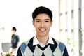 Portrait of young attractive asian creative man smiling and looking at camera