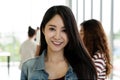 Portrait of young attractive asian creative woman or designer smiling and looking at camera