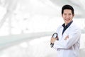 Portrait of young attractive asian doctor or physician man crossed arms holding stethoscope medical equipment Royalty Free Stock Photo
