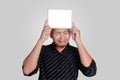 Young Asian Man Showing Small Whiteboard Covering His Head Royalty Free Stock Photo