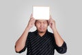 Young Asian Man Showing Small Whiteboard Covering His Head Royalty Free Stock Photo