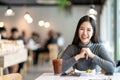 Portrait of young attractive asian woman looking at camera smiling with positive urban lifestyle concept