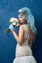 Portrait of young attractive bride on blue background Royalty Free Stock Photo