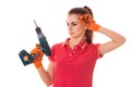 Portrait of young attractive brunette building woman in red uniform with drill in hands makes renovation isolated on Royalty Free Stock Photo