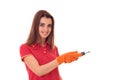 Portrait of young attractive brunette building woman in red uniform with screwdriver in hands makes renovation and Royalty Free Stock Photo