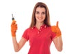 Portrait of young attractive brunette building woman in red uniform with screwdriver in hands makes renovation smiling Royalty Free Stock Photo