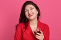 Portrait of young attractive brunette woman with glass of white wine in hands, lady posing isolated over pink studio background, Royalty Free Stock Photo