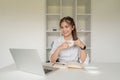 Portrait of young attractive business asian woman with relax while holding a coffee mug sitting at her office desk Royalty Free Stock Photo