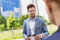 Portrait of young attractive businessman holding two cups of coffee Royalty Free Stock Photo