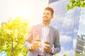 Portrait of young attractive businessman holding two cups of coffee Royalty Free Stock Photo