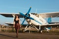 Portrait of young attractive caucasian brunette girl looking at camera with sensual sight outdoor in summer near airplane Royalty Free Stock Photo