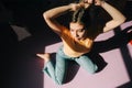 Portrait of young attractive caucasian woman sitting on a floor in a bedroom in sunlight Royalty Free Stock Photo