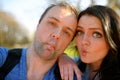 Portrait of young attractive couple having emotional fun tomfoolery together.