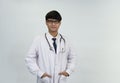 Portrait young attractive doctor in uniform with  stethoscope standing isolated on white background Royalty Free Stock Photo