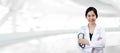 Portrait of young attractive female asian doctor or physician crossed arms holding stethoscope medical Royalty Free Stock Photo