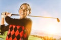 Portrait of young attractive female Golfer teeing off Royalty Free Stock Photo
