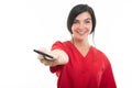 Portrait of young attractive female nurse handing telephone