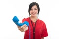 Portrait of young attractive female nurse handing telephone receiver