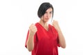 Portrait of young attractive female nurse showing fists like fighting