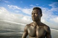 Portrait of young attractive and fit black afro American man with strong muscular body posing cool model attitude on the beach