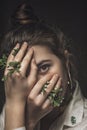 Portrait of a young attractive girl covering her one eye with a palm. Beautiful brunette woman closing her eyes with her hand. I Royalty Free Stock Photo