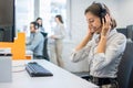 Portrait of young attractive happy smiling female customer support phone operator at modern office workplace Royalty Free Stock Photo