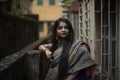 Portrait of young and attractive Indian Bengali brunette woman in traditional dress