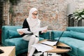 Portrait of a young, attractive Muslim woman, wearing turban hijab, headscarf, entrepreneur or businesswoman, working on Royalty Free Stock Photo