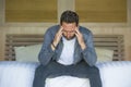Portrait of young attractive overwhelmed and depressed man sitting on bed worried and frustrated suffering depression crisis fired Royalty Free Stock Photo