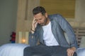 Portrait of young attractive overwhelmed and depressed man sitting on bed worried and frustrated suffering depression crisis fired Royalty Free Stock Photo