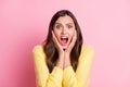 Portrait of young attractive scared afraid shocked terrified girl hold hands on cheeks on pink color background